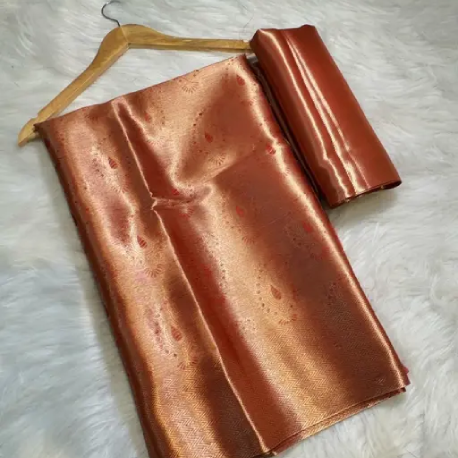 Handwoven metallic saree in soft silver, rose‑gold or charcoal tones with subtle zari shimmer.
